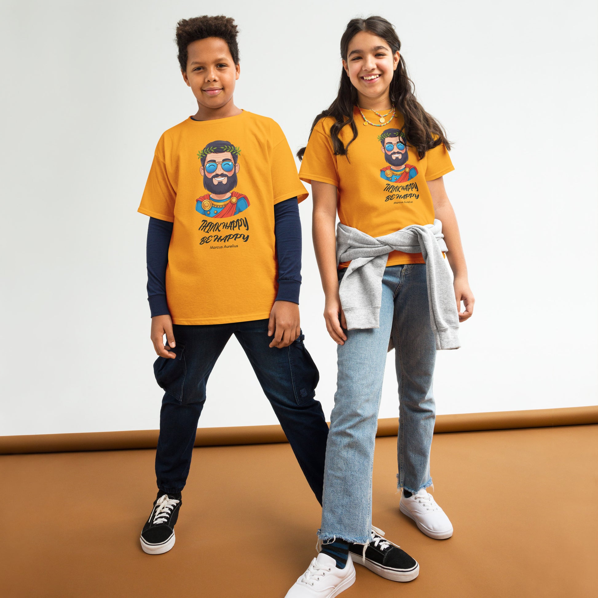 Two children wearing matching yellow t-shirts with a graphic design on a white background.
